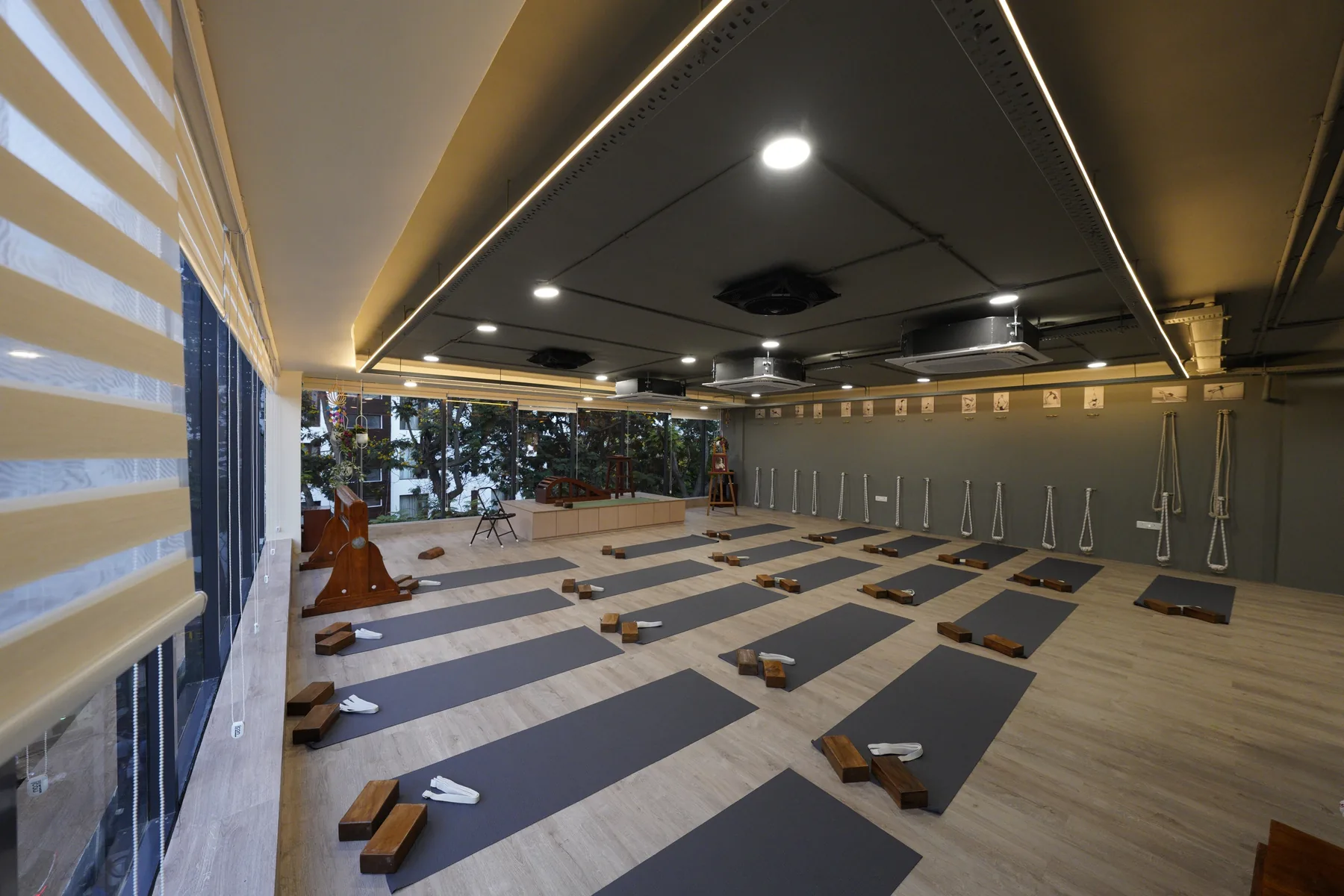 The practice hall with rows of mats, wooden blocks and belts, and ropes along the far wall