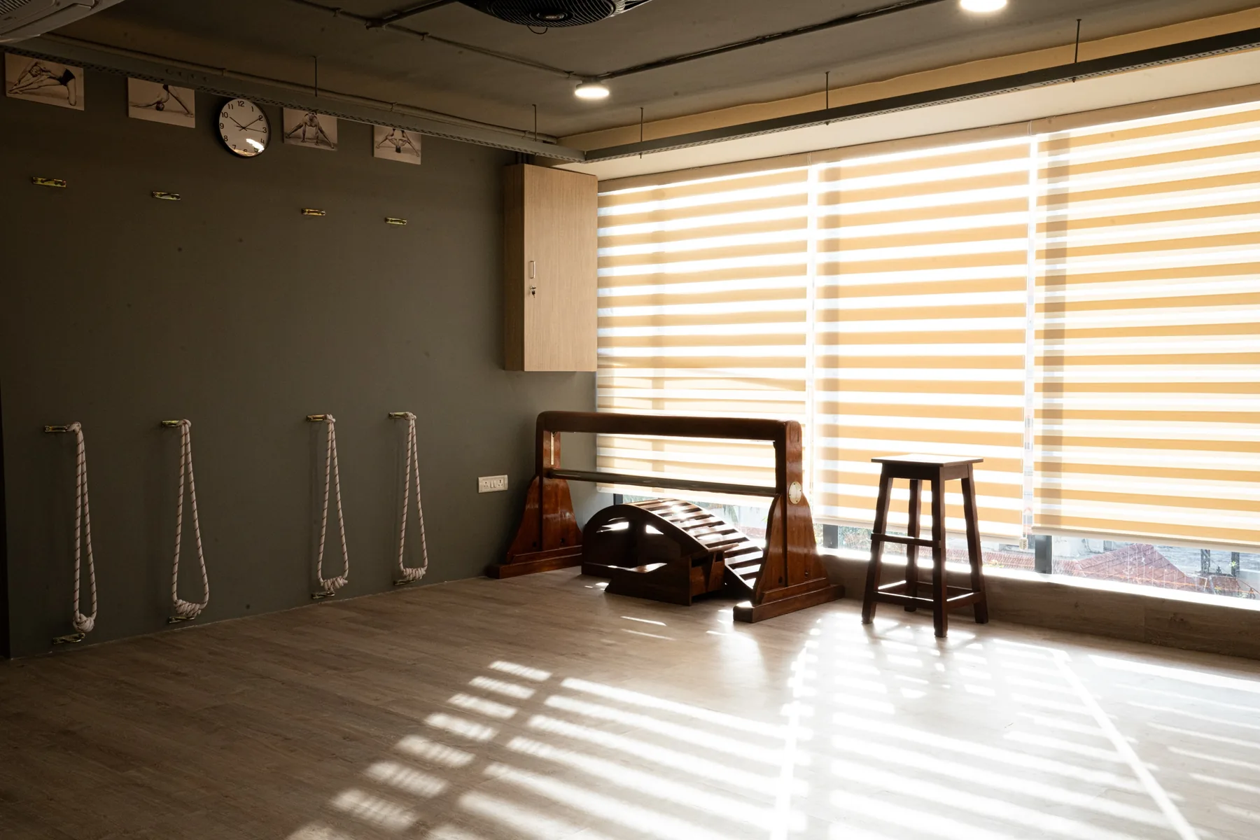 The rope wall of the practice hall with afternoon light through the blinds