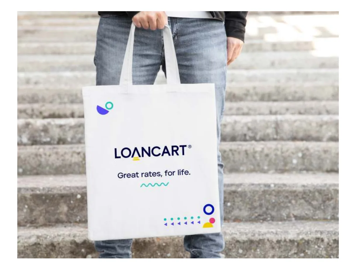 A tote bag with the logotype and tagline
