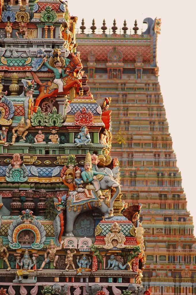 The painted tiers of a south Indian temple tower, crowded with carved figures
